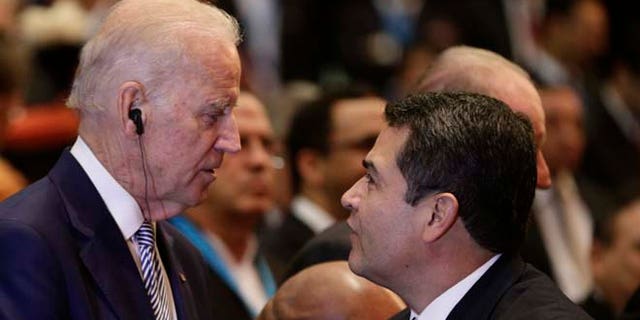 U.S. Vice President Joe Biden, center, talks with Honduras' President Juan Orlando Hernandez as Cuba's Vice President Salvador Valdes Mesa stands left, at the swearing-in ceremony for Guatemala's new President Jimmy Morales inside the National Theater in Guatemala City, Thursday, Jan. 14, 2016. The TV comic and political neophyte was inaugurated amid uncertainty over how he plans to run the Central American nation beset by entrenched poverty, corruption and violent criminal gangs. (AP Photo/Arnulfo Franco)