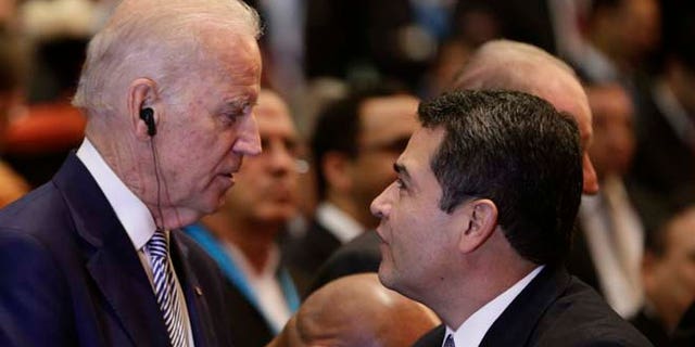U.S. Vice President Joe Biden, center, talks with Honduras' President Juan Orlando Hernandez as Cuba's Vice President Salvador Valdes Mesa stands left, at the swearing-in ceremony for Guatemala's new President Jimmy Morales inside the National Theater in Guatemala City, Thursday, Jan. 14, 2016. The TV comic and political neophyte was inaugurated amid uncertainty over how he plans to run the Central American nation beset by entrenched poverty, corruption and violent criminal gangs. (AP Photo/Arnulfo Franco)