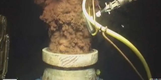 FILE - In this Monday July 12, 2010 image from video made available by BP PLC, oil flows out of the top of the transition spool, which was placed into the gushing wellhead and will house the new containment cap, at the site of the Deepwater Horizon oil spill in the Gulf of Mexico. (AP Photo)