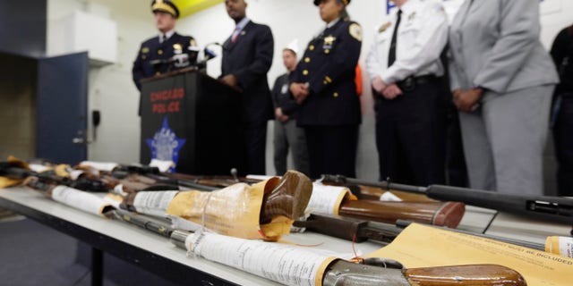 FILE - In this Jan. 28, 2013, file photo, Chicago Police First Deputy Superintendent Alfonsa Wysinger, second from left, speaks at a news conference in Chicago with a display of recently seized guns, part of the 574 that had been seized in the city since Jan. 1. The mounting homicide toll in President Barack Obamas hometown has giving ammunition to both sides in the nations debate about gun rights and safety. On Monday, Jan. 6, 2014, a federal judge in Chicago potentially opened a new market to gun dealers after ruling as unconstitutional Chicago ordinances that aim to reduce gun violence by banning their sale within the city's limits. (AP Photo/M. Spencer Green, File)