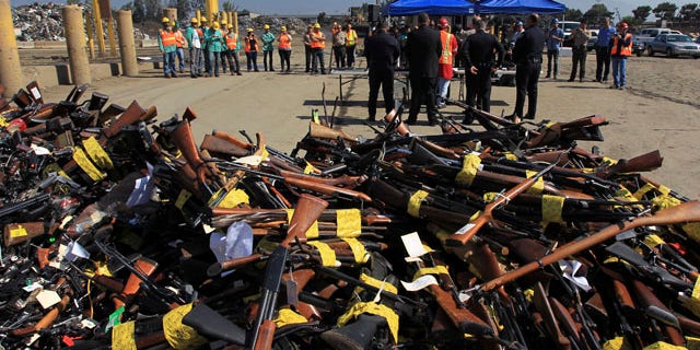 July 30, 2013: Guns to be melted lie in a pile near a news conference at the Los Angeles County Sheriff's Department's 20th annual Gun Melt at the Gerdau Steel Mill in Rancho Cucamonga, California.