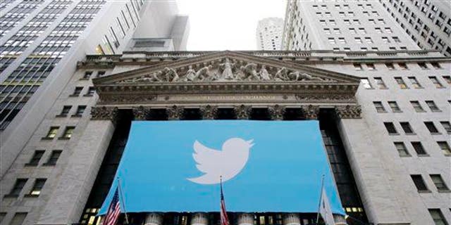 In this Thursday, Nov. 7, 2013 file photo, a banner with the Twitter logo hangs on the facade of the New York Stock Exchange.
