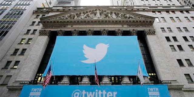 In this Thursday, Nov. 7, 2013 file photo, a banner with the Twitter logo hangs on the facade of the New York Stock Exchange.