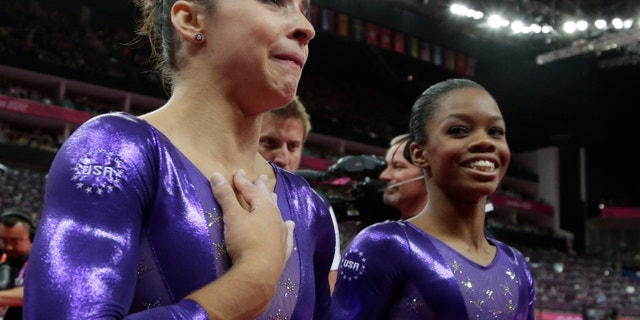 Ju;y 20, 2012: U.S. gymnast Alexandra Raisman, left, reacts after qualifying for the women's all-around final along with teammate Gabrielle Douglas during the Artistic Gymnastics women's qualification at the 2012 Summer Olympics.