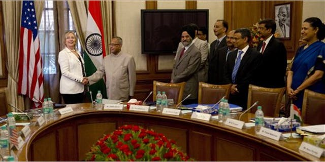 July 19: Indian Finance Minister Pranab Mukherjee shakes hands with U.S. Secretary of State Hillary Clinton prior to a meeting at the Cabinet Secretariat in New Delhi, India.