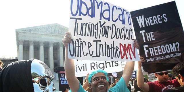 WASHINGTON, DC - JUNE 28: Anti-Obamacare protesters wear masks of U.S. President Barack Obama and Grim Reaper as they demonstrate in front of the U.S. Supreme Court June 28, 2012 in Washington, DC. The Supreme Court is expected to hand down its ruling on the Affordable Healthcare Act this morning. (Photo by Alex Wong/Getty Images)