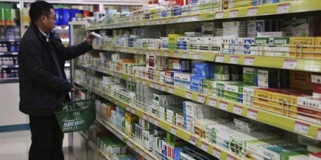 March 8, 2014: A customer shops at a pharmacy in Xuchang, Henan province.