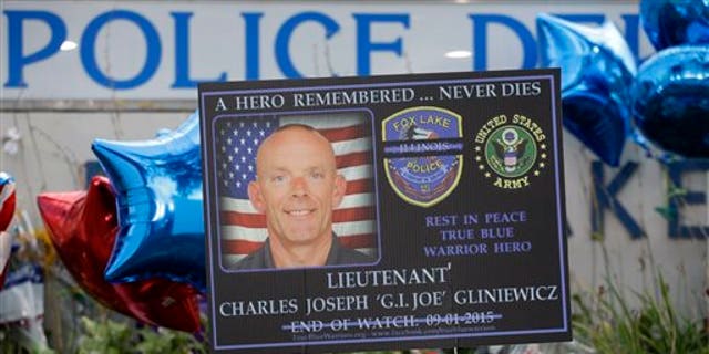 A memorial is in place at the Fox Lake Police Department on Wednesday, Sept. 2, 2015, in Fox Lake, Ill. for murdered officer, Lt. Charles Joseph Gliniewicz. (AP Photo/Nam Y. Huh)
