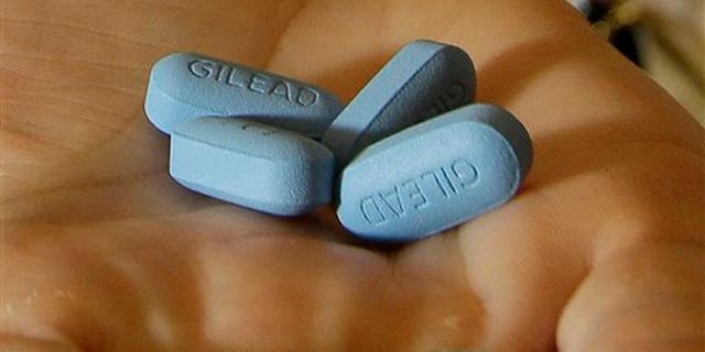 In this Thursday, May 10, 2012 file photo, a doctor holds Truvada pills at her office in San Francisco. (AP Photo/Jeff Chiu)