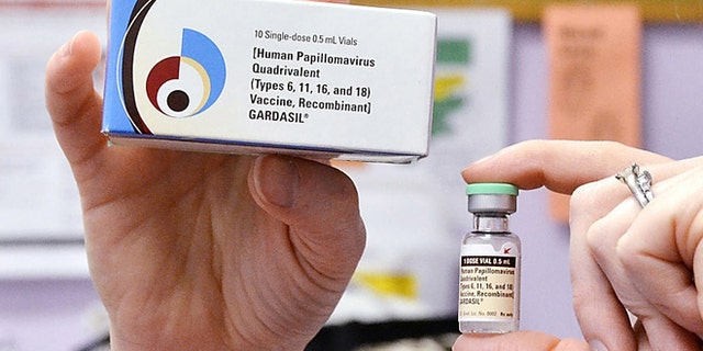 A child health nurse holds up a vial and box for the HPV vaccine, brand name Gardasil, at a clinic in Kinston, N.C.