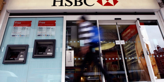 FILE - In this Feb. 27, 2012 file photo, a pedestrian passes a branch of HSBC bank in London. The chair of parliaments Public Accounts Committee says the former chief of HSBC must face serious questions after once-secret papers outlined how the bank helped the wealthy dodge taxes. Margaret Hodge told the BBC on Monday, Feb. 9, 2015 that Stephen Green, HSBCâs former CEO, was either "asleep at the wheel, or he did know and he was therefore involved in dodgy tax practices." (AP Photo/Kirsty Wigglesworth, File)