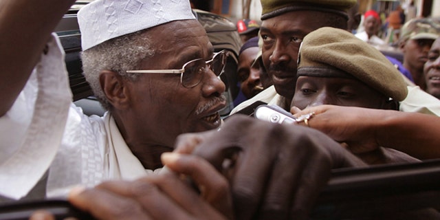In this Friday, Nov. 25, 2005, file photo, Former Chad dictator Hissene Habre, left, seen as he leaves the court in Dakar, Senegal. A French lawyer for ex-Chadian dictator Hissene Habre confirms he has been charged with war crimes, crimes against humanity and torture by a special court set up in Senegal to try him.