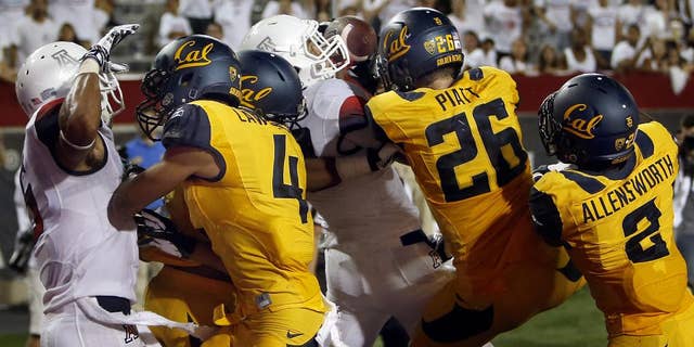 In this Sept. 20, 2014, photo, Arizona running back Austin Hill, center in white, catches a pass for a touchdown in the middle of California defenders including Kenny Lawler (4), Griffin Piatt (26) and Darius Allensworth (2) with no time left on the clock at Arizona Stadium in Tucson, Ariz. Anu Solomon hit Hill with the 47-yard Hail Mary to send the stunned Bears to a 49-45 loss. One part planning and two parts_ at least_ luck, that desperation heave to the end zone rarely results in a touchdown. (AP Photo/Arizona Daily Star, Kelly Presnell ) ALL LOCAL TELEVISION OUT; PAC-12 OUT; MANDATORY CREDIT