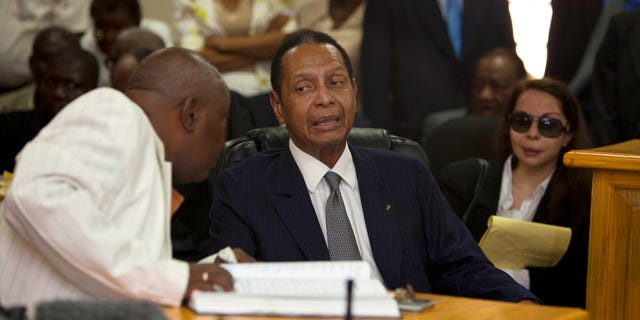 Feb. 28, 2013: Former Haitian dictator Jean-Claude Duvalier, known as "Baby Doc," center, attends his hearing as his companion Veronique Roy sits behind, right, inside a courthouse in Port-au-Prince, Haiti.