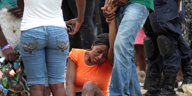 June 7: A woman reacts at the site of a deadly landslide in Port-auPrince, Haiti. Heavy rain hammered southern Haiti for a seventh straight day on Tuesday, triggering floods and mudslides and causing houses and shanties in the capital to collapse.