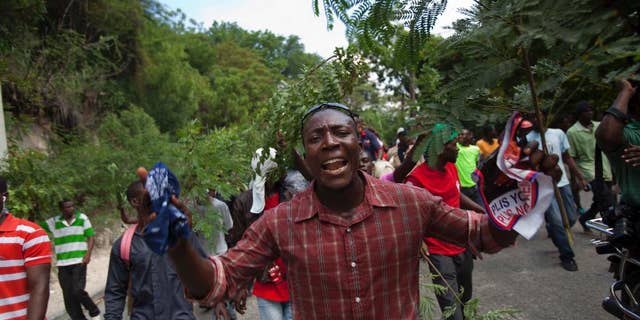Demonstrators march during an anti-government protest in Port-au-Prince, Haiti, Sunday, Oct. 26, 2014. A few thousand protesters allied with Haiti’s opposition marched through neighborhoods of the capital demanding the chance to vote in legislative and local elections that are three years late, among other grievances. (AP Photo/Dieu Nalio Chery)
