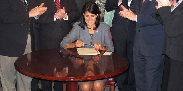South Carolina Gov. Nikki Haley signs a bill that requires the state's General Assembly to record all its votes on budget items and final votes on other legislative matters, April 12,2011. (FNC)