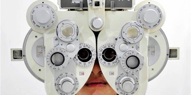 A near-sighted girl receives an eye sight examination.