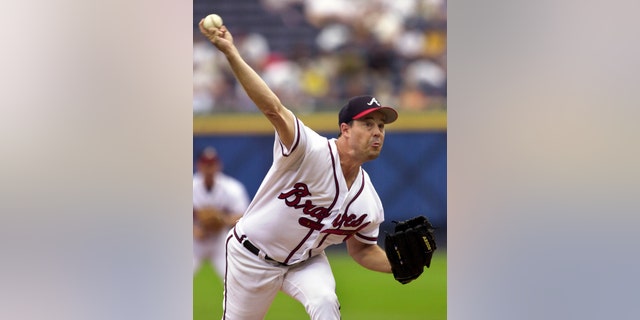 Sept. 22, 2002: In this file photo, Atlanta Braves starting pitcher Greg Maddux delivers to a Florida Marlins batter in the first inning of a baseball game at Turner Field in Atlanta.