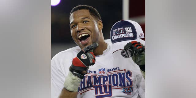 In this Feb. 3, 2008, file photo, New York Giants defensive end Michael Strahan celebrates after the Giants defeated the New England Patriots 17-14 in the Super Bowl XLII football game in Glendale, Ariz. (AP Photo/David J. Phillip)