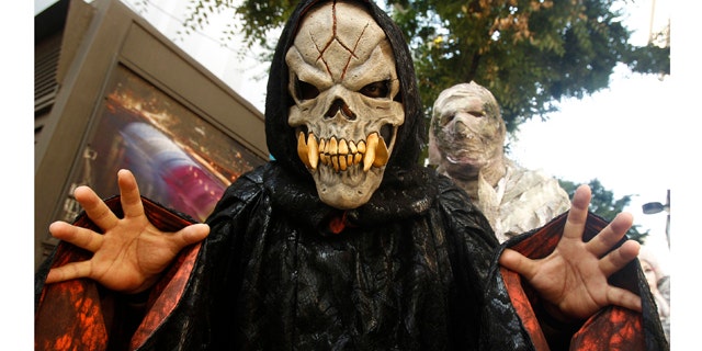 Costumed performers from an amusement park pose during a promotional event "Happy Halloween & Horror Night" at the Myeongdong shopping district in Seoul September 5, 2011. The event was held to generate publicity for activities in Everland Amusement Park during the Halloween season from September 9 to October 31. REUTERS/Truth Leem (SOUTH KOREA - Tags: SOCIETY)