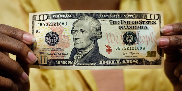 FILE - In this March 2, 2006, file photo, a $10 bill, featuring a likeness of Andrew Hamilton, the first U.S. Treasury secretary, is displayed at the National Archives gift shop, in Washington. U.S. Treasury officials declined to comment Monday, April 18, 2016, on the specifics of a CNN report that Treasury Secretary Jacob Lew has decided to keep Hamilton on the $10 bill, and instead replace seventh U.S. President Andrew Jackson's portrait on the $20 bill with a woman who represents the struggle for racial equality. (AP Photo/J. Scott Applewhite, File)