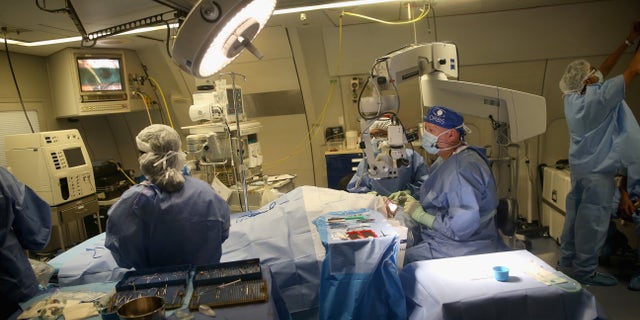 KOLKATA, INDIA - SEPTEMBER 19: (EXCLUSIVE COVERAGE) Dr Roberto Pineda performs a corneal transplant in the operating theatre on the converted DC-10 Aircraft that charity Orbis uses as a flying opthalmic hospital at Kolkata airport on September 19, 2013 in Kolkata, India. During her solo visit to India the Countess is supporting the sight saving charity ORBIS. The Countess witnessed patients' surgery and met patients' during her tour of the plane. She also met medical volunteers from around the world who share their skills with local eye care workers to improve eye care in local communities. (Photo by Chris Jackson/Getty Images)