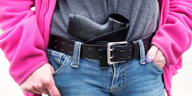 Gloria Lincoln-Thompson of Garden City, Mich., carries her Smith & Wesson Shield 9mm pistol in her belt while participating in a rally and march supporting Michigan's Open Carry law April 27, 2014 in Romulus, Mich. (Getty Images)