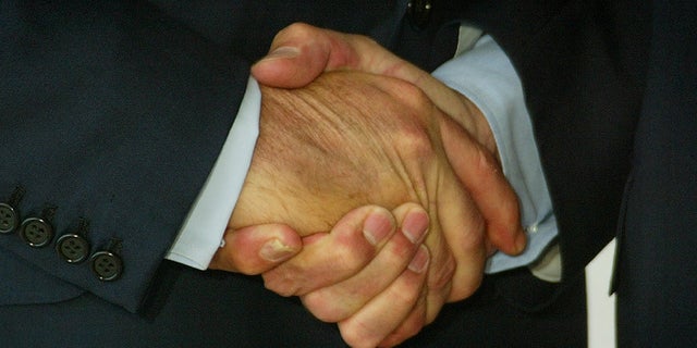 Close-up of the handshake between U.S. President George W.Bush (L) andFrench President Jacques Chirac (R), in Evian June 1, 2003 at themeeting site of the G8 summit, June 1-3, 2003. Leaders of the Group ofEight - the United States, Japan, Germany, France, Britain, Italy,Canada and Russia join counterparts from 12 major developing countriesto discuss debt relief, AIDS and access to clean water. REUTERS/PeterMacDiarmidJES/WS