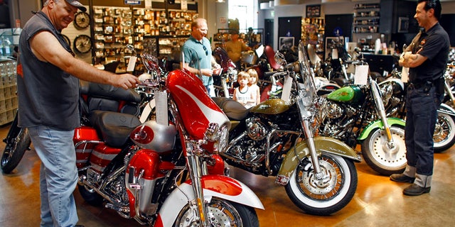 FILE - In this Aug. 31, 2007 file photo, a new 2008 Harley-Davidson Screamin' Eagle Ultra motorcycle is seen at the Harley-Davidson of Glendale dealership in Glendale, Calif. Harley-Davidson has agreed to pay $15 million to settle a complaint filed by federal environmental officials over racing tuners that caused its motorcycles to emit higher than allowed levels of air pollution. (AP Photo/Damian Dovarganes, File)