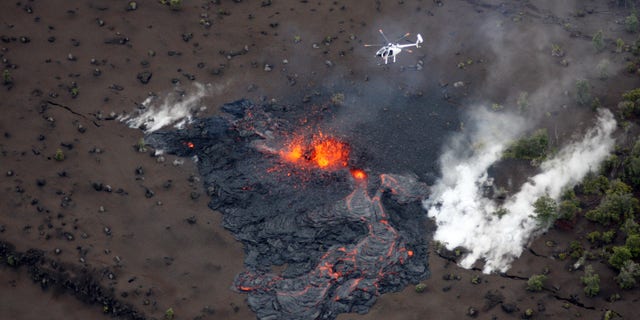 March 6: Scientists fly in a helicopter above the Pu'u O'o vent on Kilauea Volcano in Hawaii. Scientists say the Pu'u O'o crater floor has collapsed and an eruption occurred along the middle of Kilauea Volcano's east rift zone.