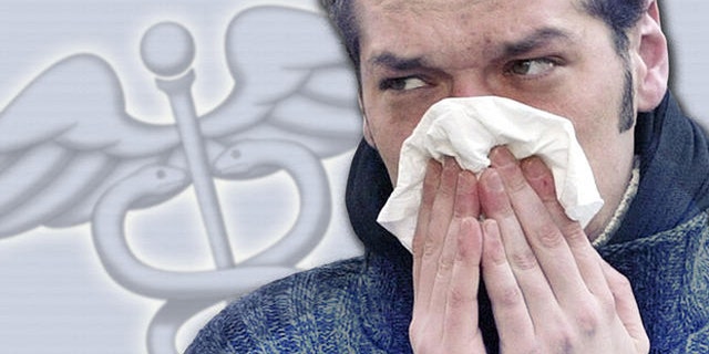 ** ILLUSTRATION ** Ein junger Mann schnaeuzt am Mittwoch, 5. November 2003, vor einer Apotheke in der Hamburger Innenstadt seine Nase. (AP Photo/Christof Stache)