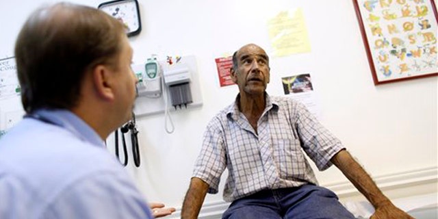 FILE: June 27, 2012: A patient talks with a doctor at Camillus Health Concern, in Miami.