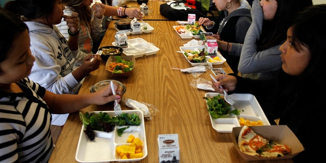 Students sit down to eat a healthy lunch at Marston Middle School in San Diego, California.
