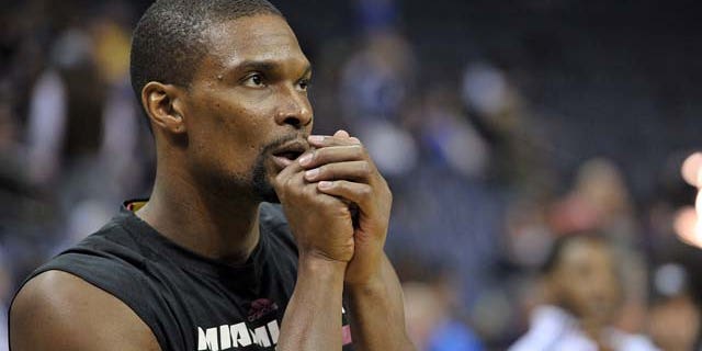 FILE - In this Dec. 7, 2014, file photo, Miami Heat center Chris Bosh warms up before an NBA basketball game against the Memphis Grizzlies in Memphis, Tenn. (AP Photo/Brandon Dill, File)