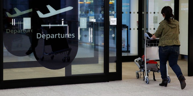 A passenger enters departures in Terminal 2 at Heathrow Airport in London July 3, 2014.