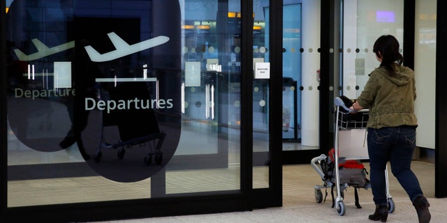 A passenger enters departures in Terminal 2 at Heathrow Airport in London July 3, 2014.