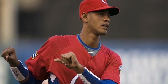 FILE - In this March 10, 2009, file photo, Cuba's Hector Olivera attends training before a World Baseball Classic game against Australia in Mexico City. Hector Olivera and the Los Angeles Dodgers have agreed to a $62.5 million, six-year contract, agent Greg Genske said. The agreement includes a $28 million signing bonus, Genske said Tuesday, March 24, 2015.(AP Photo/Claudio Cruz, File)