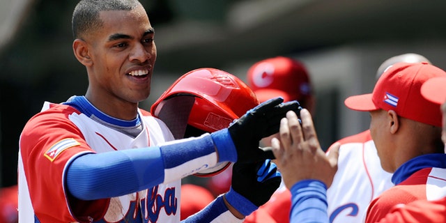 MEXICO CITY - MARCH 08: Hector Olivera #28 of Cuba is congratulated by his teammates after hitting a home run against South Africa during the 2009 World Baseball Classic Pool B match on March 8, 2009 at the Estadio Foro Sol in Mexico City, Mexico. (Photo by Kevork Djansezian/Getty Images) *** Local Caption *** Hector Olivera