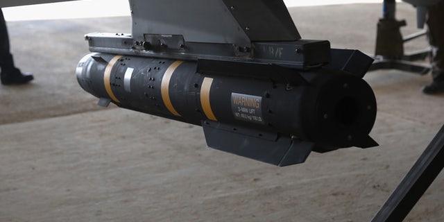 A Hellfire missile hangs from a U.S. Air Force MQ-1B Predator unmanned aerial vehicle (UAV), at a secret air base in the Persian Gulf region on January 7, 2016. (Photo by John Moore/Getty Images)