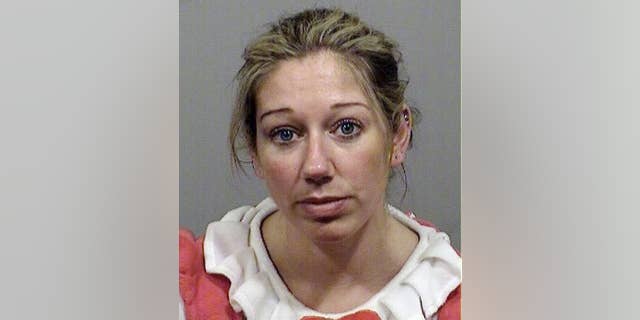 This booking photo provided Monday, Oct. 27, 2014 by the Cumberland County Sheriff's Office Jail shows Carrie Gipson of Westbrook, Maine, who was arrested on drunken driving charges early Sunday, Oct. 26, in Gorham, Maine. Police said that Gipson, 37, who was wearing a red and white Hello Kitty costume, minus the doll’s mammoth head, was stopped because she driving in the wrong lane. (AP Photo/Cumberland County Sheriff's Office Jail)