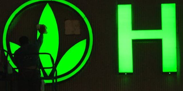 FILE - In this Friday, Sept. 8, 2006, file photo, provided by Herbalife, a worker cleans the logo on the Herbalife sign as finishing touches are put on the company's new building in Torrance, Calif. Herbalife Ltd. says that it is facing an inquiry from the Federal Trade Commission. Herbalife said that it received the civil investigative demand from the FTC on Wednesday, March 12, 2014. The FTC's website says that these are used to investigate possible "unfair or deceptive acts or practices." A representative from the FTC was not immediately available to elaborate. (AP Photo/Herbalife, Susan Goldman, File)