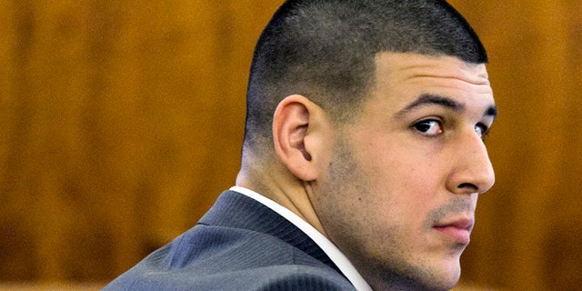 Former New England Patriots football player Aaron Hernandez looks at the prosecutor during his murder trial at Bristol County Superior Court Tuesday, March 3, 2015, in Fall River, Mass.  Hernandez is accused of the June 2013 killing of Odin Lloyd. (AP Photo/Dominick Reuter)