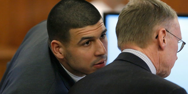 Former New England Patriots football player Aaron Hernandez, left, speaks with his defense attorney Charles Rankin, right, during his murder trial Thursday, March 12, 2015, in Fall River, Mass. Hernandez is charged with killing semiprofessional football player Odin Lloyd. (AP Photo/Steven Senne, Pool)