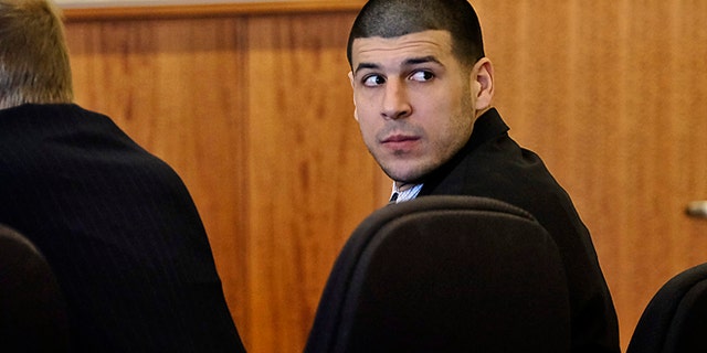 Aaron Hernandez, a former New England Patriots NFL football player, looks back towards the gallery during the pre-trial motion hearing in the Superior Court in Fall River, Mass., Friday, Dec. 12, 2014. Judge Susan Garsh says prosecutors in the murder case against Hernandez may not tell jurors about two other killings with which the he is charged. Hernandez has pleaded not guilty to murder in the 2013 killing of Odin Lloyd, a semi-professional football player who was dating the sister of Hernandez's fiancee. He has also pleaded not guilty to the fatal shootings of two men in 2012 after an encounter at a Boston nightclub. (AP Photo/The Boston Globe, Robert E. Klein, Pool)
