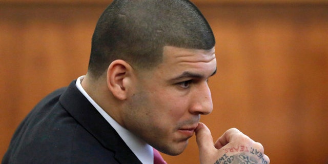 Former New England Patriots NFL football player Aaron Hernandez is seated during his murder trial, Thursday, April 2, 2015, in Fall River, Mass. Hernandez is charged with killing Odin Lloyd in June 2013. (AP Photo/Steven Senne, Pool)