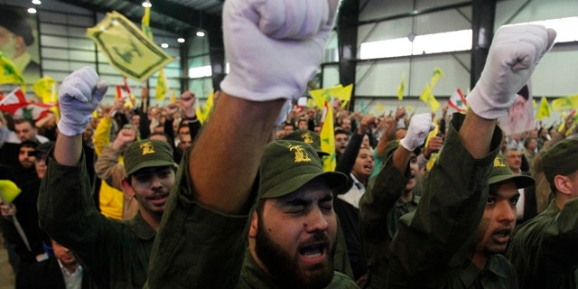 November 11, 2011: Lebanon's Hezbollah militants chant slogans as their leader Sayyed Hassan Nasrallah speaks during a rally marking Hezbollah's Martyr's Day in Beirut's suburbs