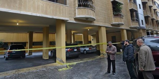 Dec. 4, 2013: Lebanese residents gather near the scene where Hassan al-Laqis, a senior commander for the Lebanese militant group Hezbollah, was gunned down outside his home, some two miles southwest of Beirut, Lebanon.
