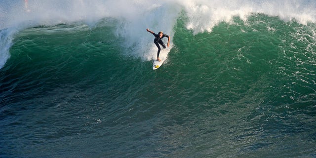 A surfer rides a high wave at The Wedge on Sept.  1, 2011, in Newport Beach, California.  (Photo by Kevork Djansezian/Getty Images)