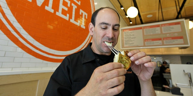 Aug. 25, 2011: Jonathan Kaplan bites into a melt called the Italian Job made with fontina and provolone cheese on garlic bread at The Melt in San Francisco. First, Flip Video camcorder creator Kaplan made it easy for consumers to shoot cheesy home movies. Now, hes hoping to popularize something cheesier and gooier by starting a grilled cheese restaurant business that combines fast food with high tech.